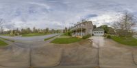 a photograph of an empty street from the fish eye view camera looking toward a house