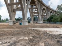 a view of an overpass going over the hill and into the distance of a building under construction