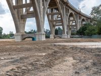 a view of an overpass going over the hill and into the distance of a building under construction