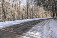 a winter road in the woods and snow on both sides and yellow signs on the middle