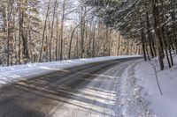 a winter road in the woods and snow on both sides and yellow signs on the middle