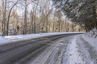 a winter road in the woods and snow on both sides and yellow signs on the middle