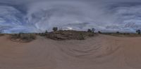 a photo of a very strange looking view of the sky and sand dunes on a cloudy day