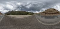 a three - dimensional photo of two roads going into a big landscape with some rocks and trees