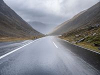 A Gloomy Day on Wet Asphalt: Austrian Mountains in the Background