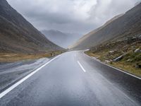 A Gloomy Day on Wet Asphalt: Austrian Mountains in the Background