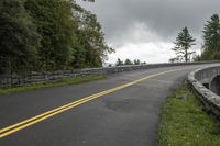 a stone roadway with a bridge spanning it's width on a cloudy day in the area