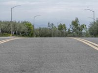 Gloomy Day with Yellow Lines on Asphalt Road