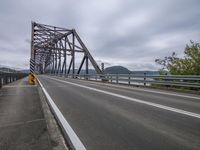 a highway with lots of traffic on it that looks like a bridge that is very high up