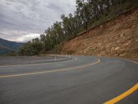 Gloomy Mountain Landscape Road with Vegetation and Rolling Clouds