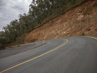 Gloomy Mountain Landscape Road with Vegetation and Rolling Clouds