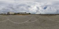 a fish - eye view shows a deserted railroad yard and a building in the distance