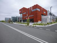 this is a shot of a parking space at an urban area with orange architecture on one side and white lines on the other