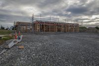 construction under construction is seen from the road and road side of a building being constructed