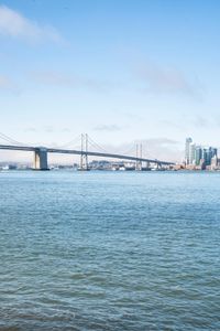 a large body of water surrounded by buildings and a city skyline on a bright day