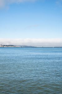 a large body of water surrounded by buildings and a city skyline on a bright day