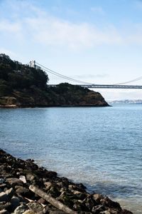 a large body of water surrounded by buildings and a city skyline on a bright day