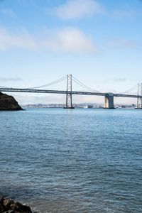 a large body of water surrounded by buildings and a city skyline on a bright day