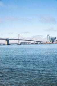 a large body of water surrounded by buildings and a city skyline on a bright day