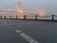 a white line marking on the street to the ground with a golden gate bridge in the background