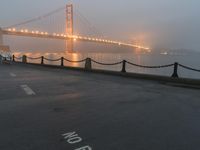 a white line marking on the street to the ground with a golden gate bridge in the background