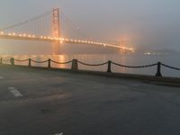 a white line marking on the street to the ground with a golden gate bridge in the background