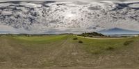 a fisheye lens view shows a golf course in the distance of the photo, as if taken from a moving vehicle