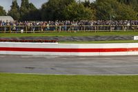 a race track with tire treads on grass and a fence around it to provide shade