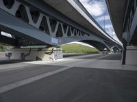 a large bridge with graffiti over a street that has a bicycle on the street next to it