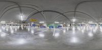 a very big white room filled with graffiti covered walls and floors - - at night