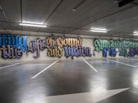 graffiti is shown on the wall of a parking garage in this image from inside a car park