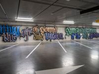 graffiti is shown on the wall of a parking garage in this image from inside a car park