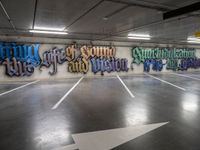 graffiti is shown on the wall of a parking garage in this image from inside a car park