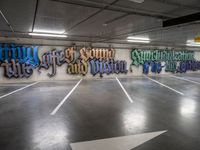 graffiti is shown on the wall of a parking garage in this image from inside a car park