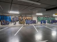 graffiti is shown on the wall of a parking garage in this image from inside a car park