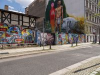 the buildings are decorated with graffiti and art on them in the city center, along with street signs