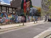 the buildings are decorated with graffiti and art on them in the city center, along with street signs