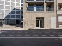 there is a grafitti on the building wall that says purpose written in graffiti