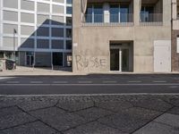 there is a grafitti on the building wall that says purpose written in graffiti