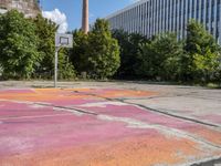 an empty parking lot in the city is cracked into two pieces and is completely painted to resemble a flower