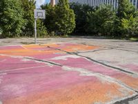 an empty parking lot in the city is cracked into two pieces and is completely painted to resemble a flower