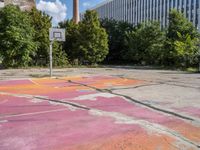 an empty parking lot in the city is cracked into two pieces and is completely painted to resemble a flower