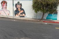 the mural on this wall is depicting mick and rod herring with music headphones and rock star hair