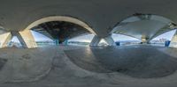 a photo of an indoor skateboard ramp near the water of a river, taken from the inside