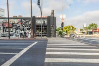 the cars are parked on the street and the white painted lines make a neat crosswalk