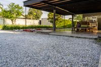 gravel area for driveways and parking in front of house with trees and walkways