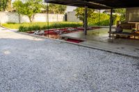 gravel area for driveways and parking in front of house with trees and walkways