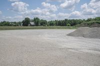 a pile of gravel is in the middle of a parking lot on a sunny day
