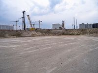 construction site with concrete structure, sky and sky line in background and construction equipment surrounding