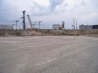 construction site with concrete structure, sky and sky line in background and construction equipment surrounding